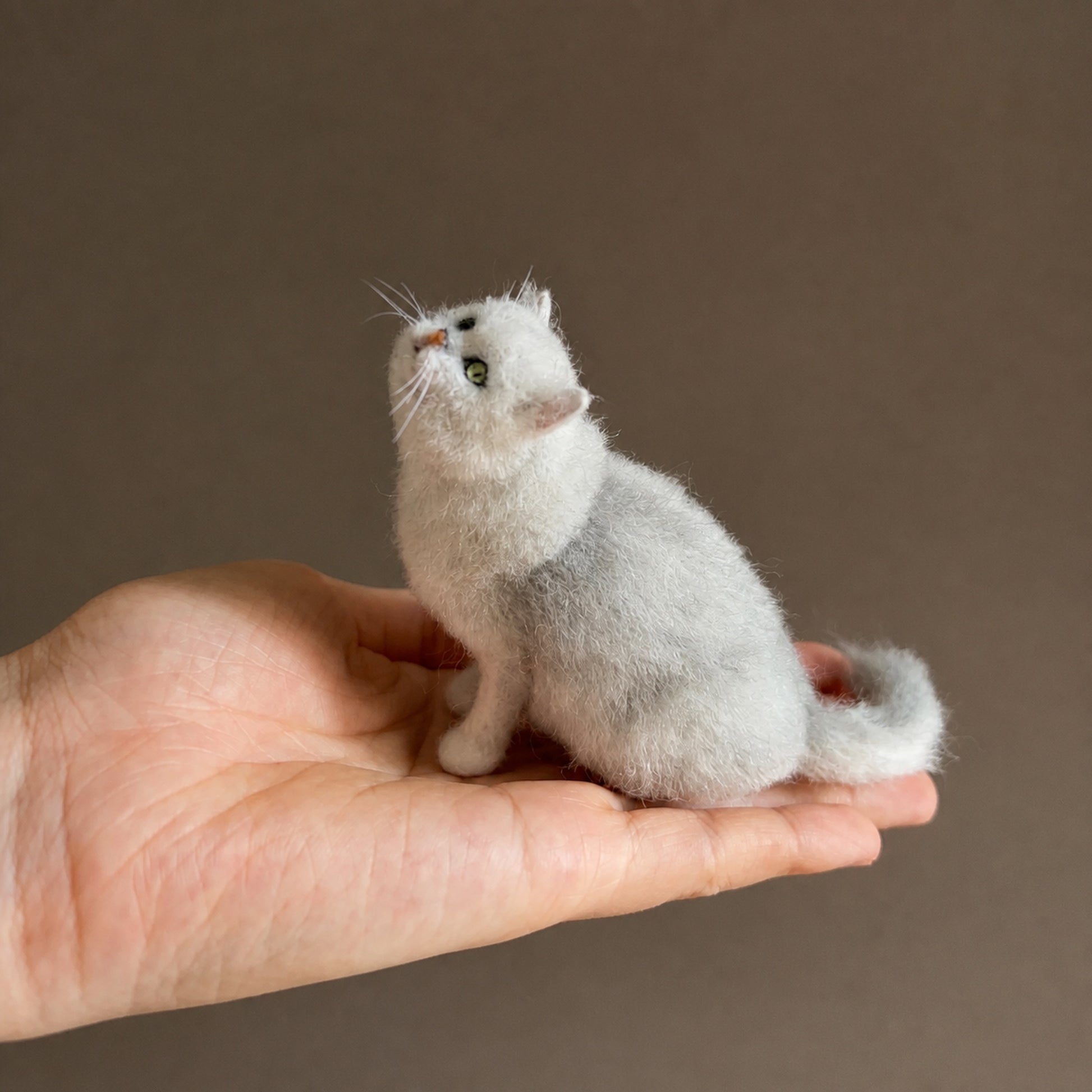 Handmade white cat mini full body wool felt figurine on a palm
